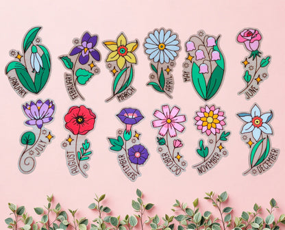 a collection of 12 magnets with a cartoon style flower of each birth flower with the month typed on it, all hand-painted and laser cut