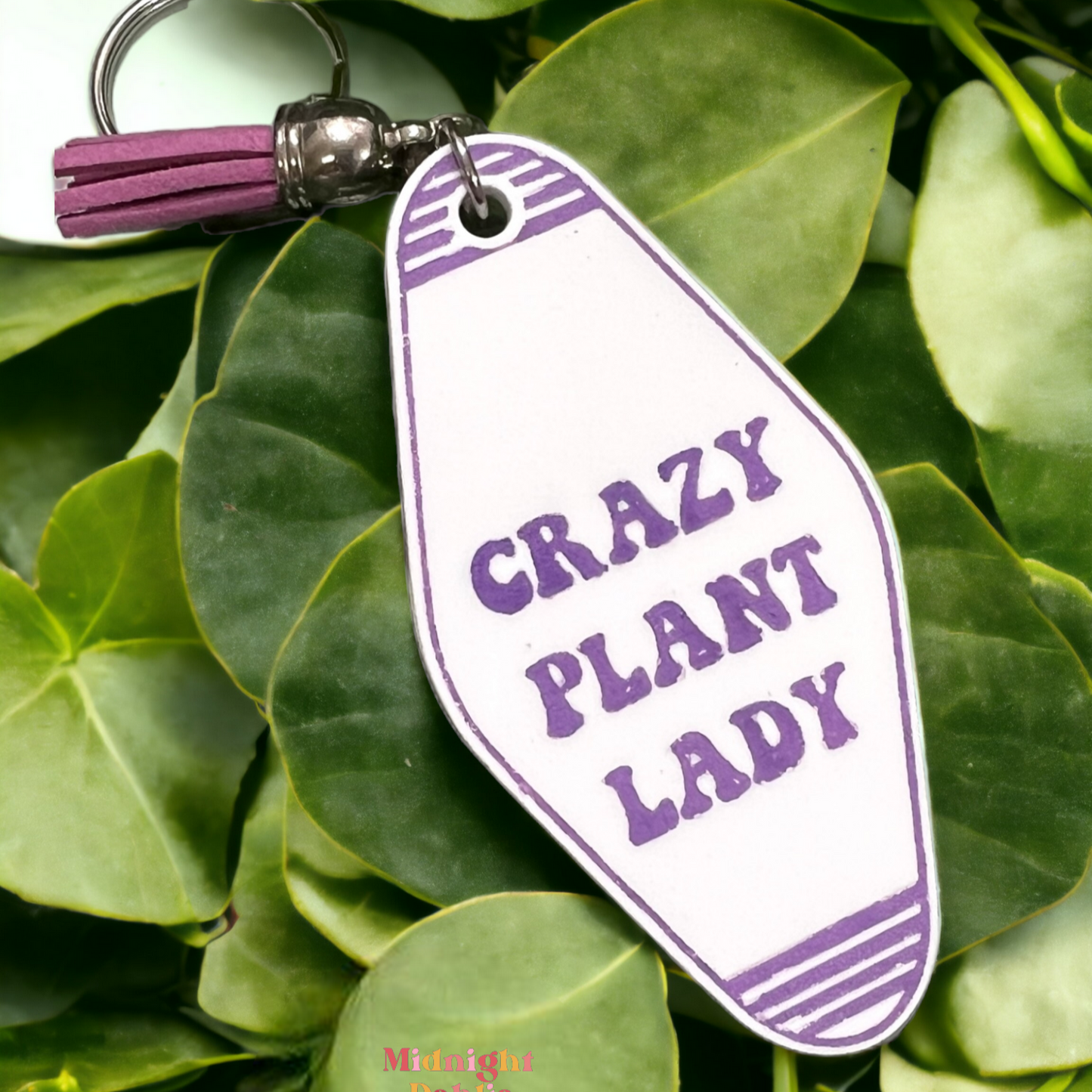 a retro motel keychain made of acrylic that reads crazy plant lady