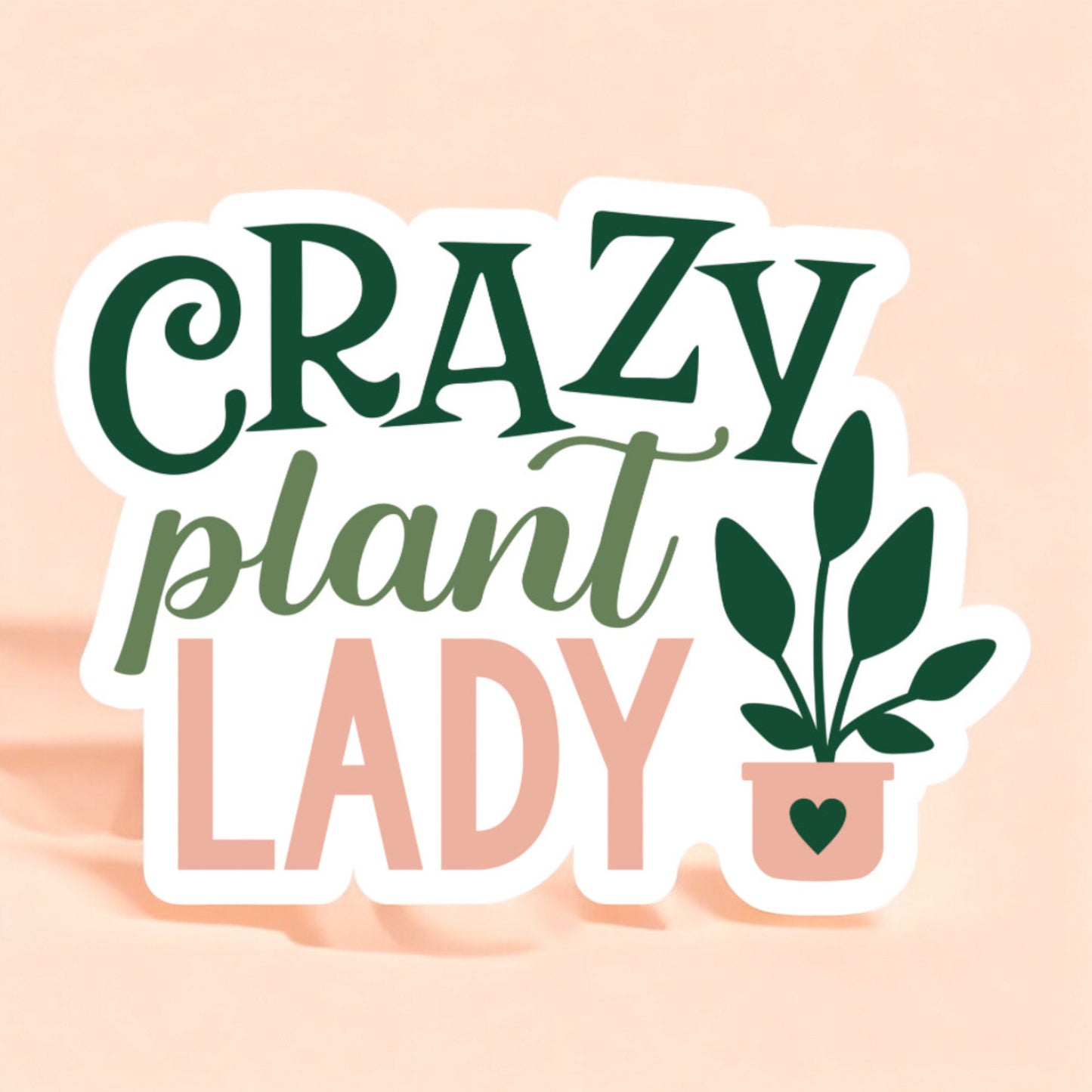 a sticker with a white background that reads crazy plant lady with a plant to the right with a pink pot and a green heart on the pot