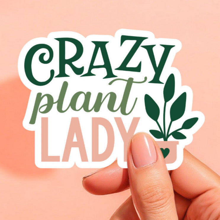 a sticker with a white background that reads crazy plant lady with a plant to the right with a pink pot and a green heart on the pot