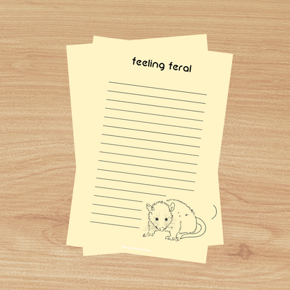 a yellow lined notepad that reads 'feeling feral' at the top and a opposum at the bottom