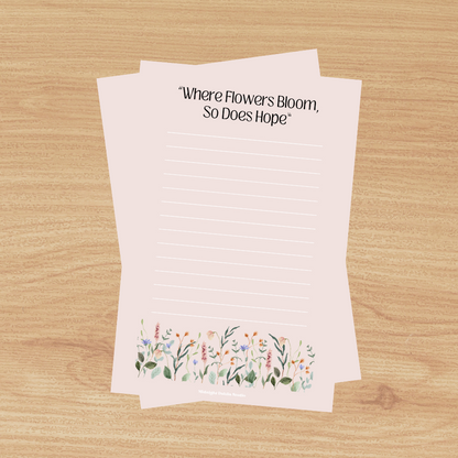 This 4"x6" notepad is made of high-quality paper, printed in house by Midnight Dahlia Studio.

It is beige and reads "Where Flowers Bloom So Does Hope" with a line of wildflowers along the bottom.  Each notepad contains 50 pages.