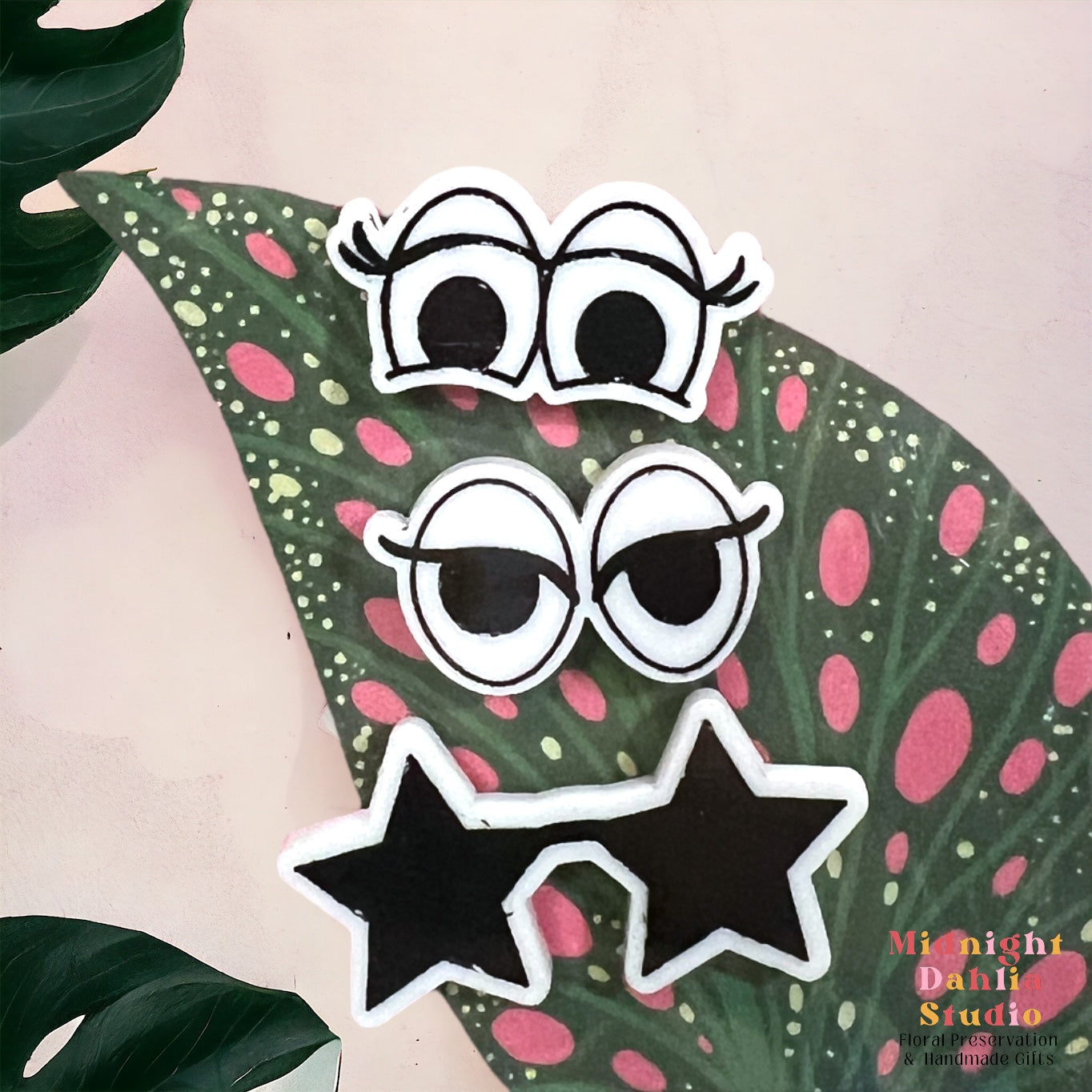 a set of three plant personality magnet with one pair of eyes with eyelashes, a pair of eyes with eyeliner, and a pair of star shaped sunglasses