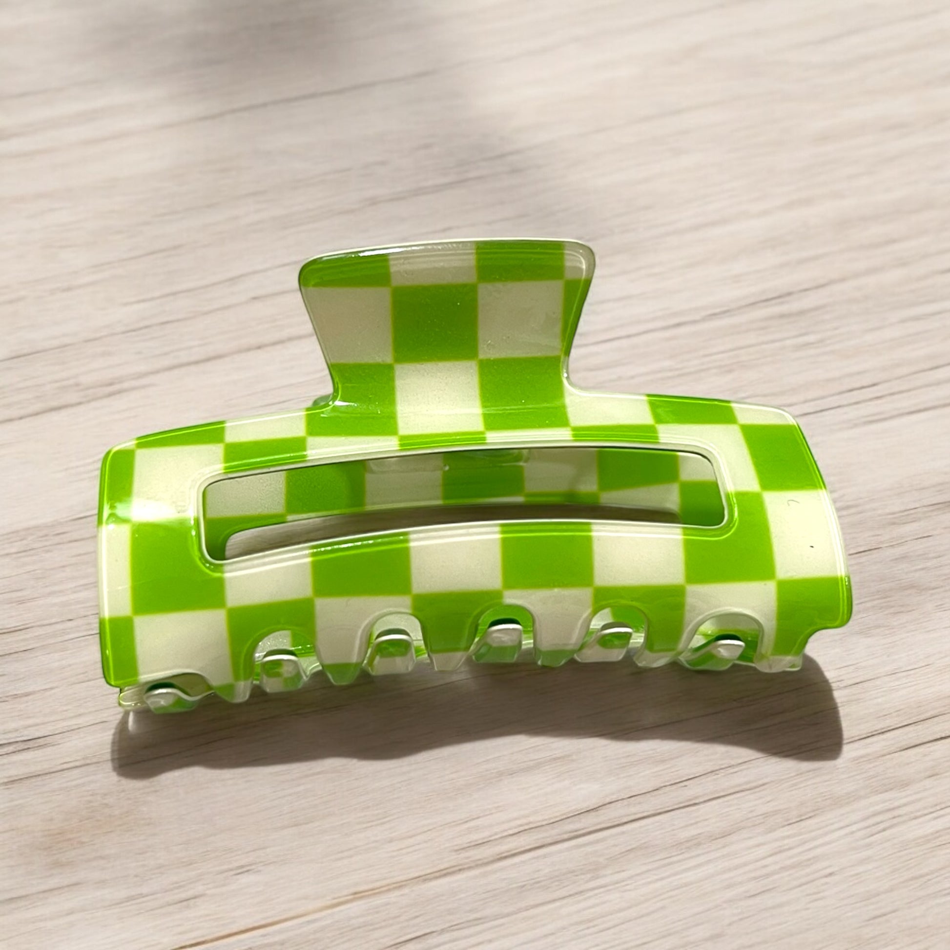 a claw clip with green and off-white checkered pattern