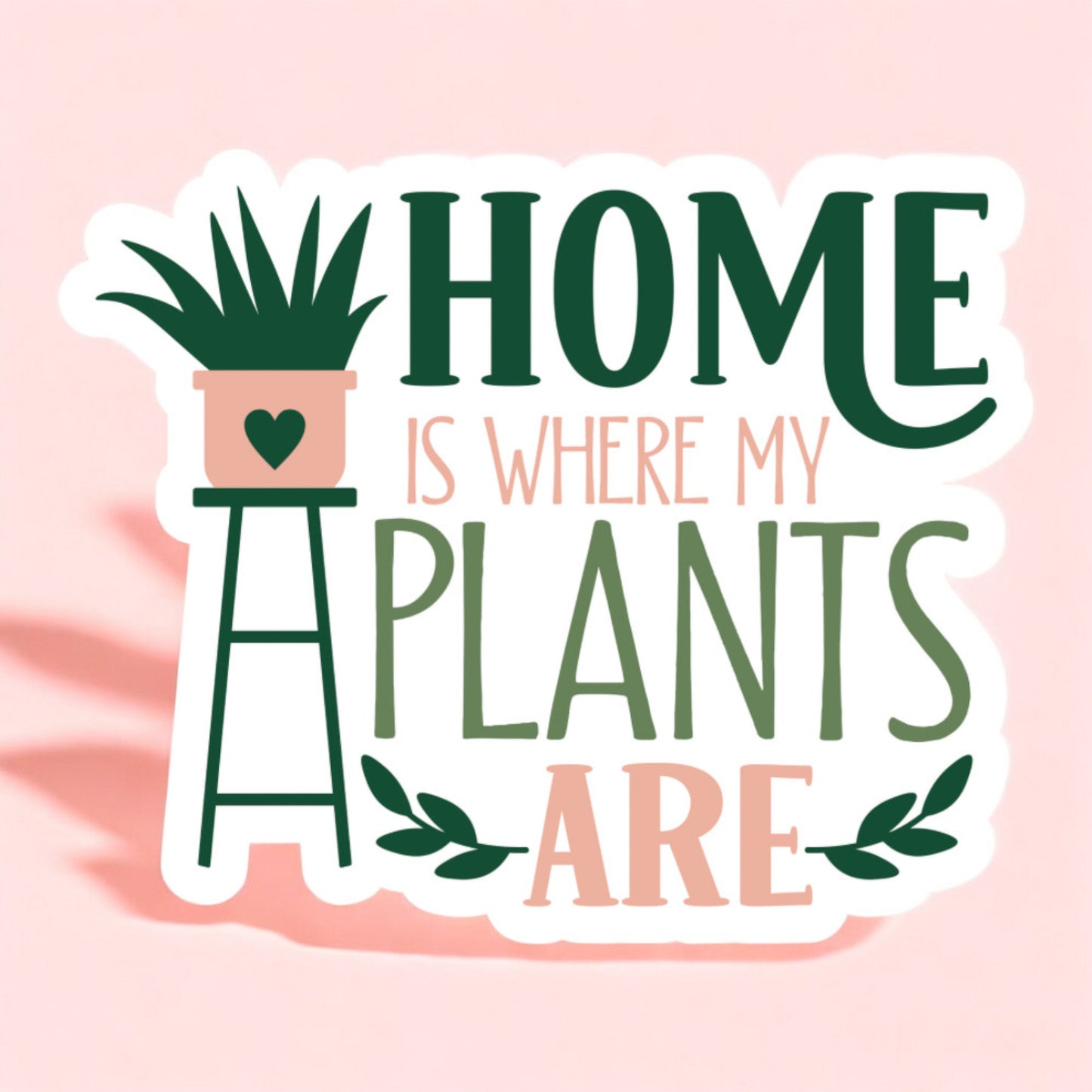 a white background sticker that reads home is where my plants are in green and peach with a plant on a stand on the left side