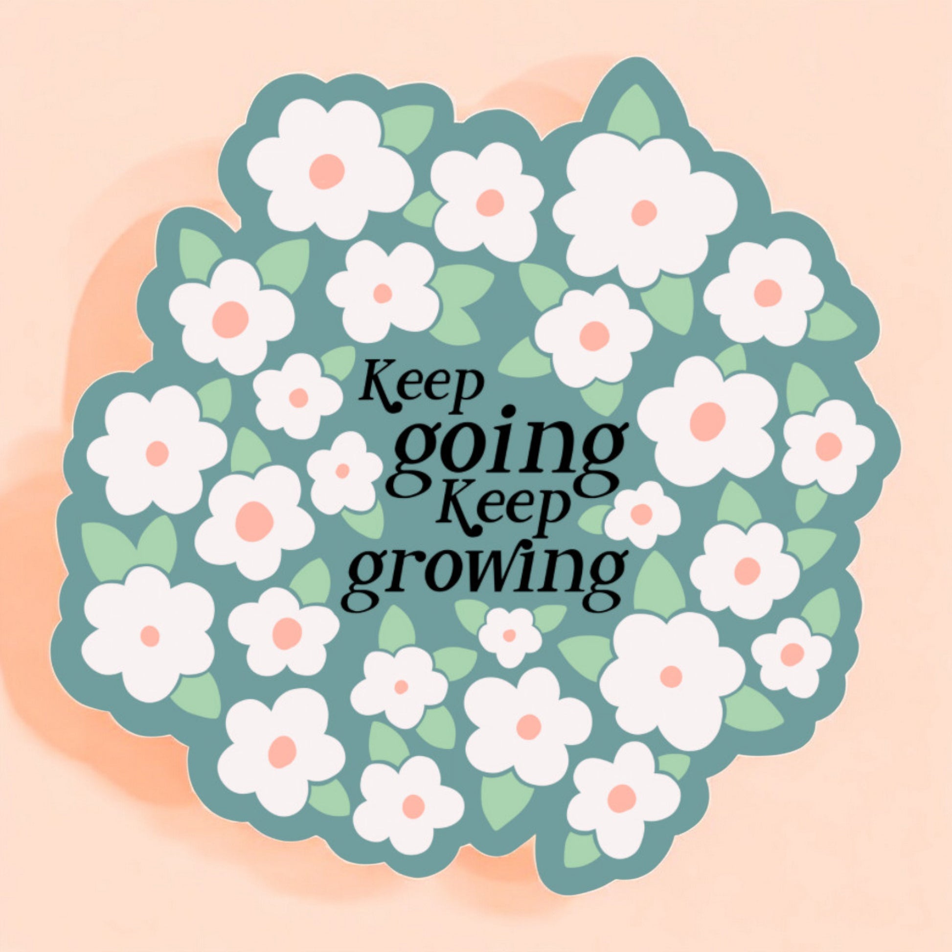 a sticker with a light blue background that reads keep going keep growing surrounded by white daisies