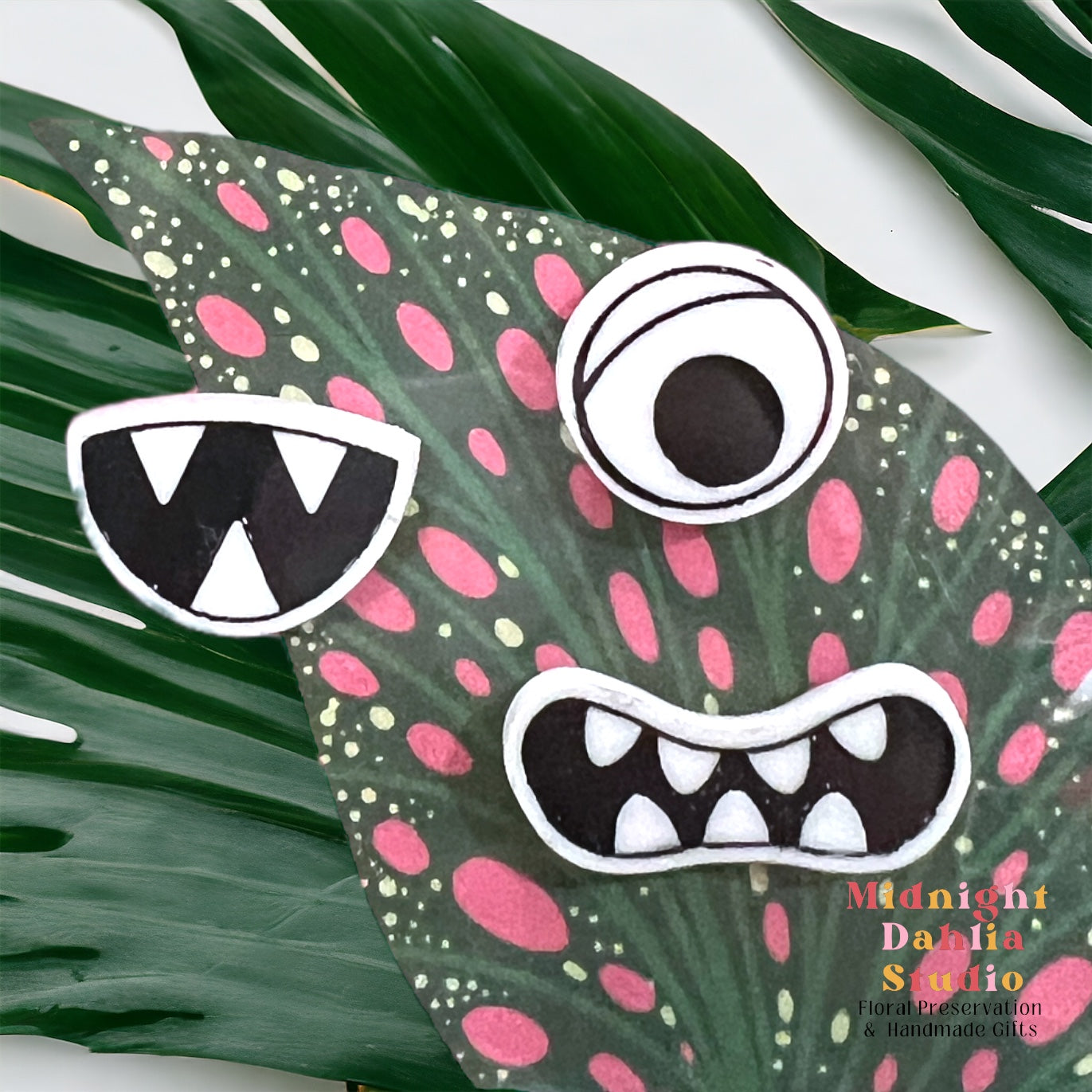 a set of three plant personality magnets including a single eye, a smile with three sharp teeth and a mouth with rounded teeth