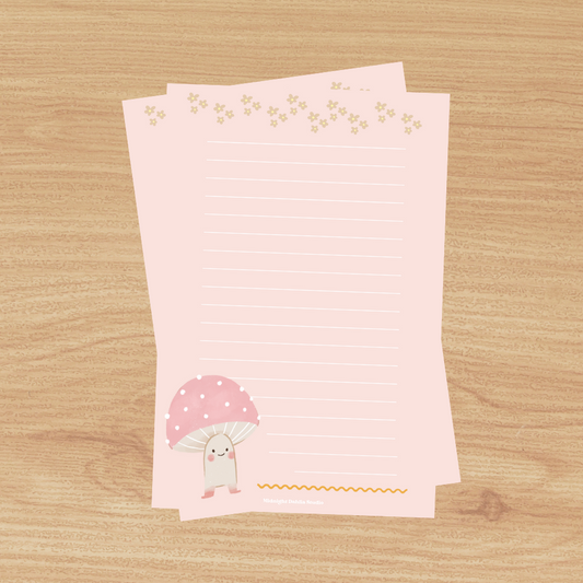 a pink lined notepad with a cute pink mushroom at the bottom