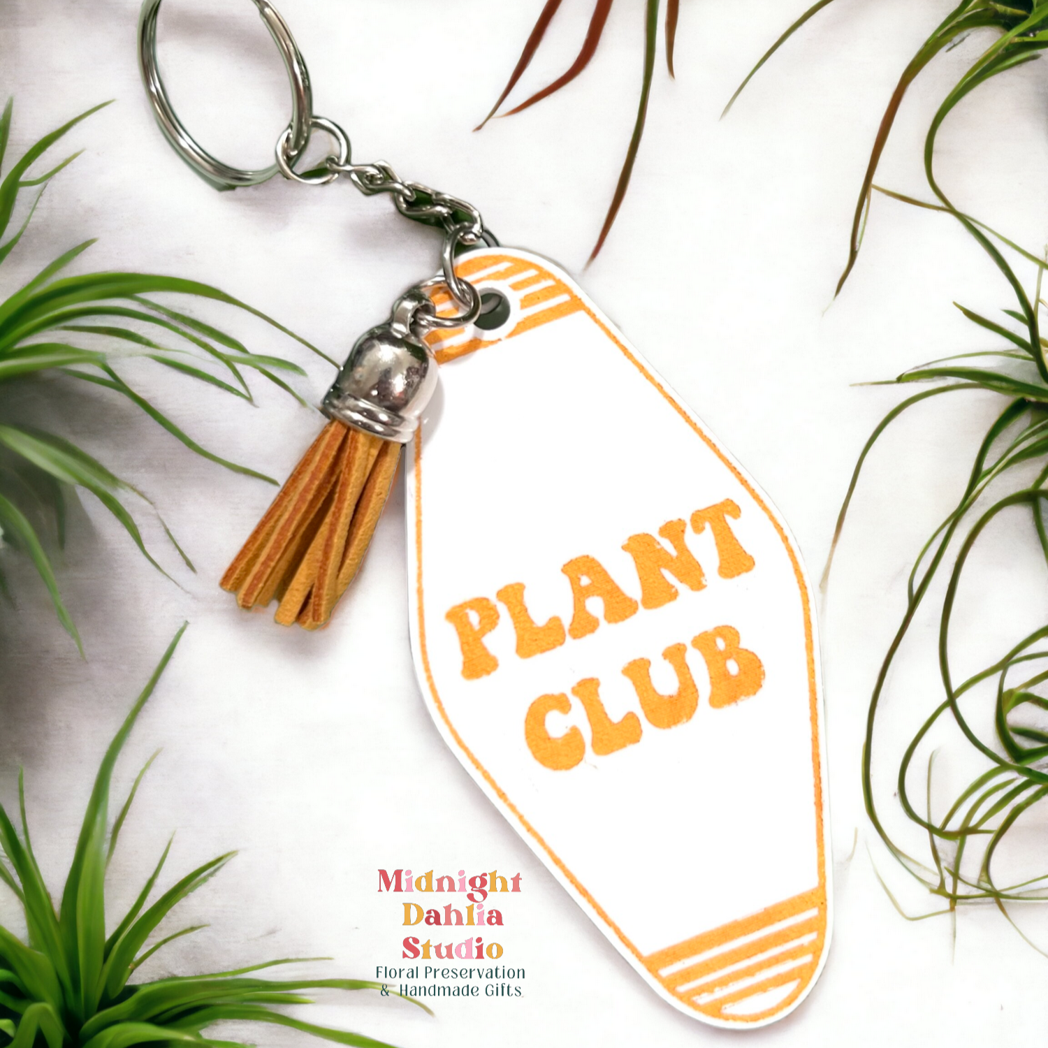 a retro motel keychain made of acrylic that reads plant club