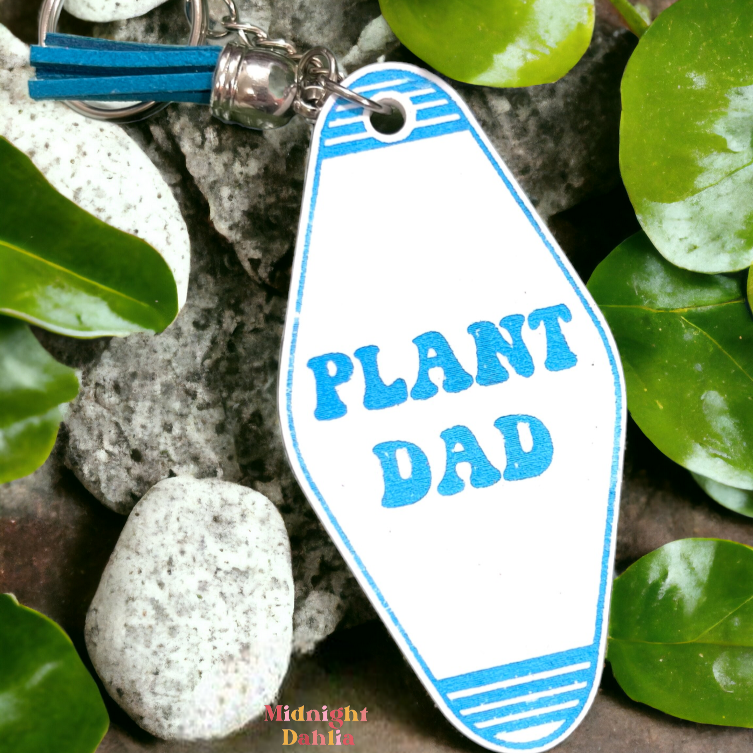 a retro motel keychain made of acrylic that reads plant dad