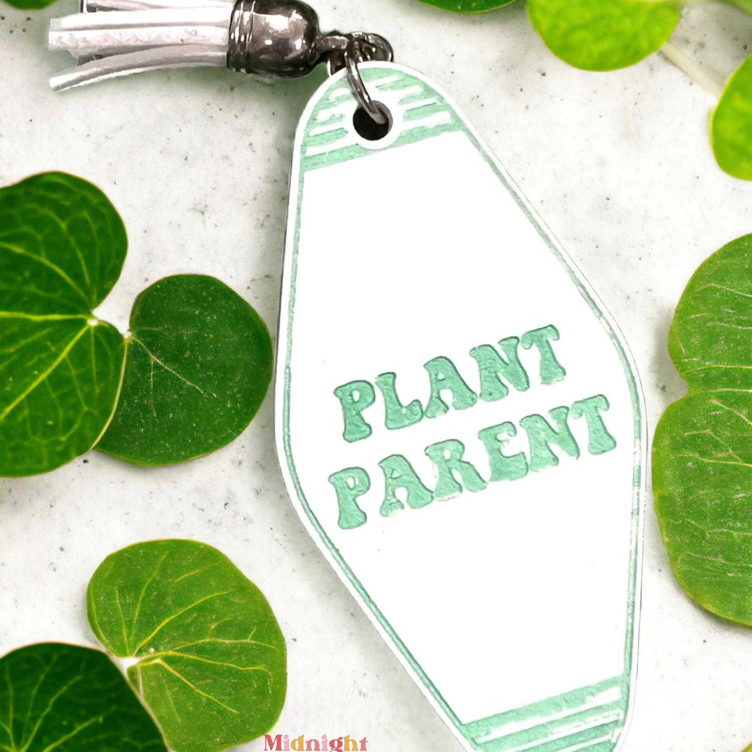 a retro motel keychain made of acrylic that reads plant parent