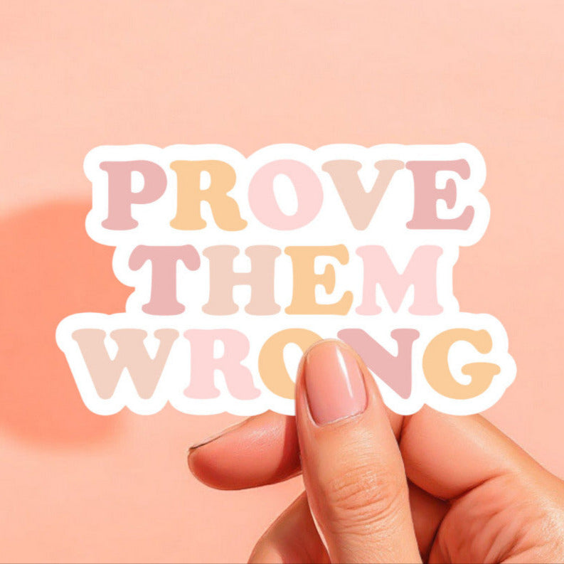 a white sticker that reads prove them wrong in pastel colors