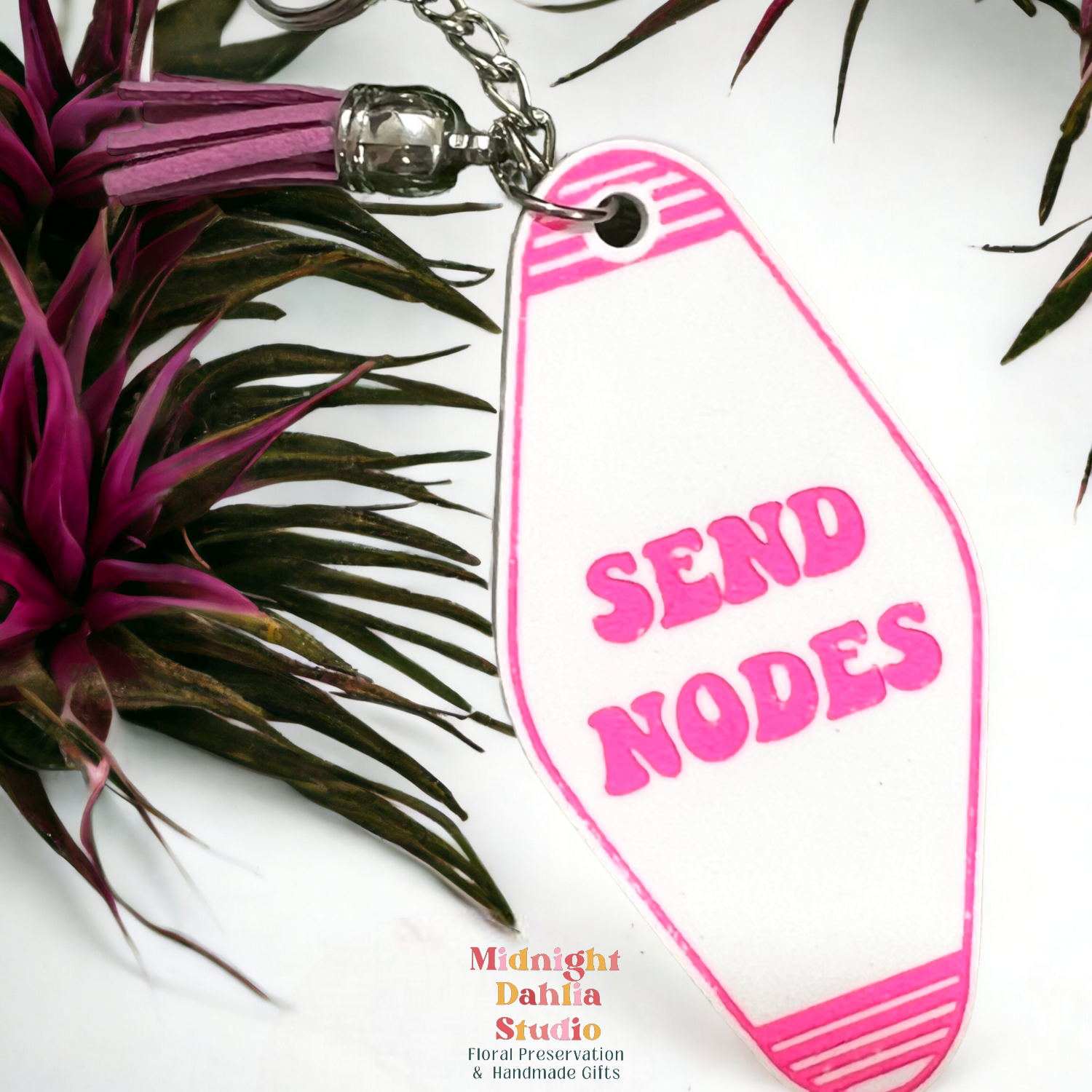 a retro motel keychain made of acrylic that reads send nodes