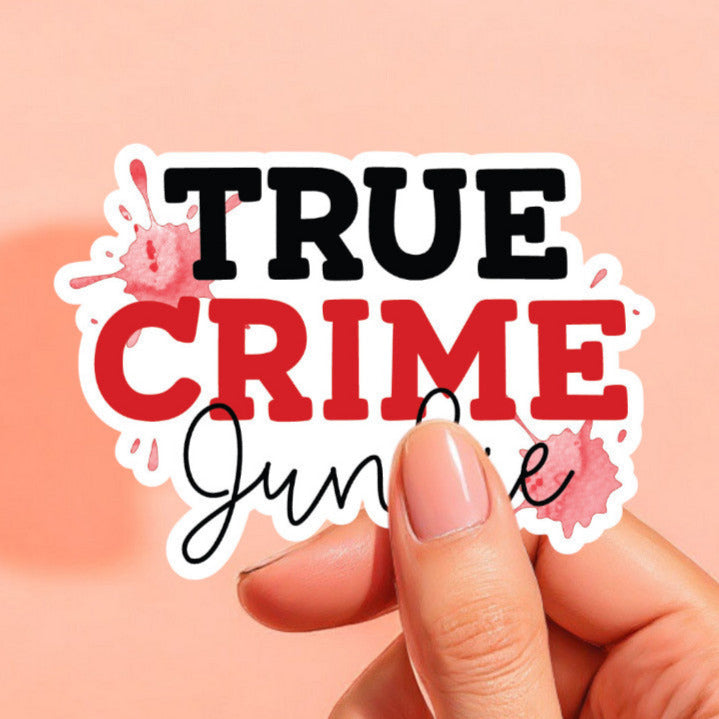 a white sticker that reads true crime junkie with red splotches in the background